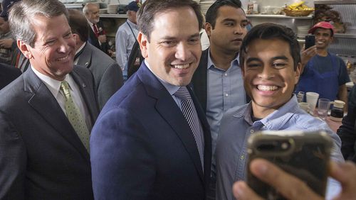 A supporter takes a selfie with Florida U.S. Sen. Marco Rubio, center, and Republican gubernatorial candidate Brian Kemp, left. (ALYSSA POINTER/ALYSSA.POINTER@AJC.COM)