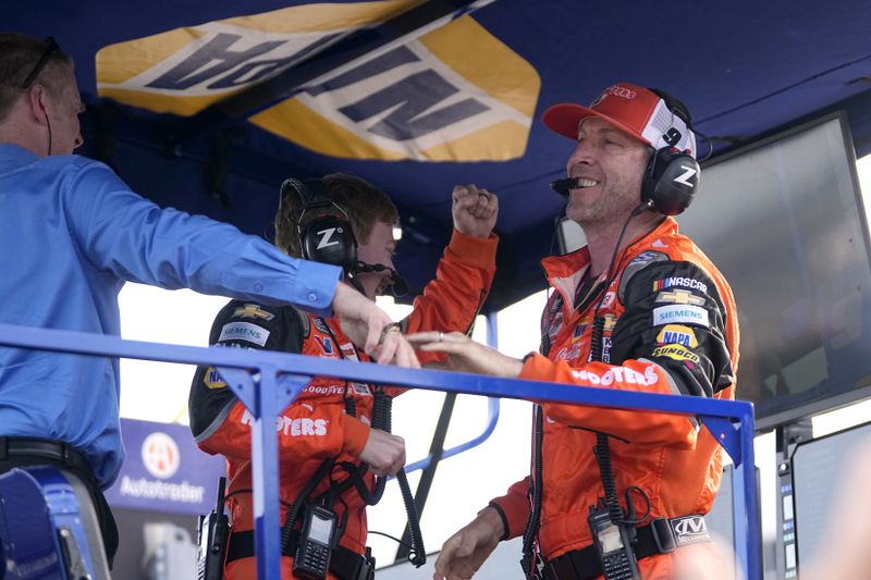 Chase Elliott's crew chief Alan Gustafson, right, celebrates with team members after winning a NASCAR Cup Series auto race at Texas Motor Speedway in Fort Worth, Texas, Sunday, April 14, 2024. (AP Photo/Tony Gutierrez)