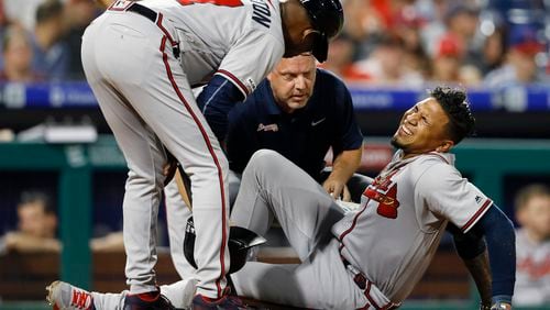 Braves' Johan Camargo reacts after an injury during the fourth inning of the team's baseball game against the Philadelphia Phillies, Wednesday, Sept. 11, 2019, in Philadelphia. (AP Photo/Matt Slocum)