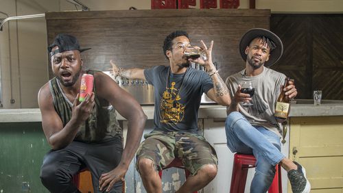 Nappy Roots group members Melvin Adams (from left) W. Hughes (center) and Blake German pose for a portrait with samples of their craft beer at Monday Night Brewing in the West End neighborhood of Atlanta. The group is launching a new beer, “Kentucky Mud.”  ALYSSA POINTER/ALYSSA.POINTER@AJC.COM
