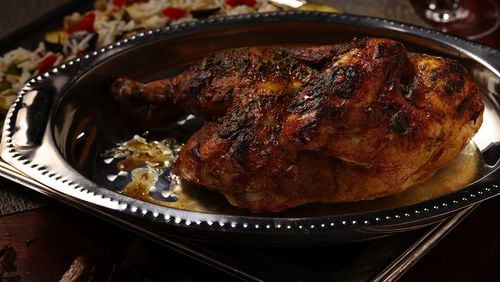 A split chicken is easier to work with than a spatchcocked bird. Before roasting, cut out the backbone with kitchen shears, then split the bird in half through the breast bone with a large chef's knife. (Mark Graham/food styling) (E. Jason Wambsgans/Chicago Tribune/TNS)