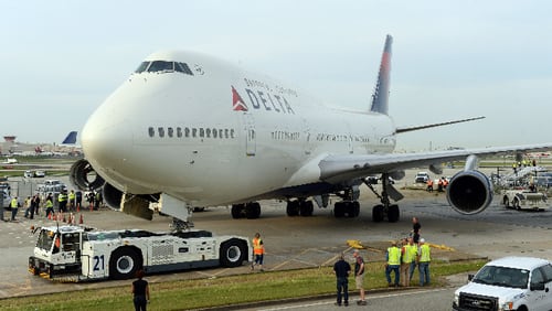 APRIL 30, 2016 ATLANTA Crews move a retired Boeing 747-400 to the Delta Flight museum Saturday, April 30, 2016. Delta Air Lines Ship 6301 made its final journey to Delta’s Atlanta world headquarters campus in preparation for the Delta Flight Museum's latest exhibit featuring the retired aircraft. KENT D. JOHNSON /kdjohnson@ajc.com #delta747experience