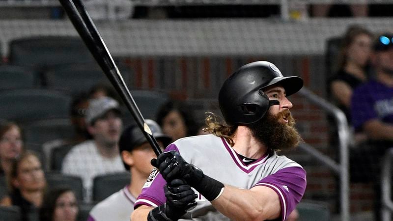 Colorado Rockies' Charlie Blackmon watches his fly ball sail toward centerfield after connecting for a two run home run during the ninth inning against the Atlanta Braves, Saturday, Aug. 26, 2017, in Atlanta.