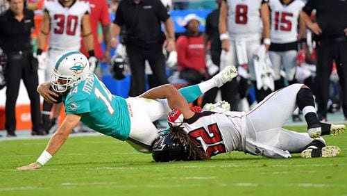 Falcons defender Austin Larkin takes down Dolphins QB Ryan Fitzpatrick during Thursday's preseason game. (Steve Mitchell-USA TODAY Sports)