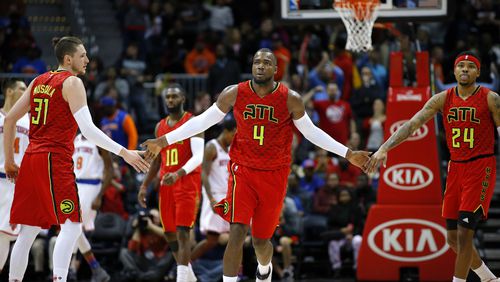 Atlanta Hawks forward Paul Millsap (4) reacts with forward Mike Muscala (31) and forward Kent Bazemore (24) in the fourth overtime of an NBA basketball game against the New York Knicks on Sunday, Jan. 29, 2017, in Atlanta. The Hawks won the game in the fourth overtime 142-139. (AP Photo/Todd Kirkland)