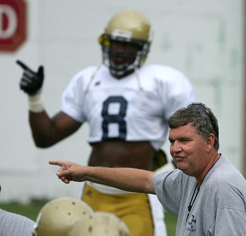 Georgia Tech head coach Paul Johnson (with a little help from Demaryius Thomas, background) shows the quarterback the directions he should throw the ball during football practice at Tech Wednesday, August 12, 2009.