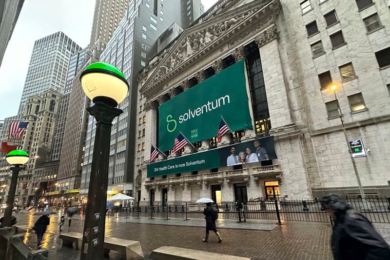 People walk past the New York Stock Exchange Wednesday, April 3, 2024 in New York. Healthcare business Solventum started trading at the NYSE on Wednesday. (AP Photo/Peter Morgan)