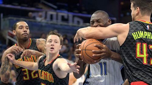 Orlando Magic forward Bismack Biyombo (11) is fouled by Atlanta Hawks forward Kris Humphries, right, while driving to the basket as Hawks guard Josh Magette (7) and forward Mike Scott (32) also help defend during the first half of an NBA preseason basketball game in Orlando, Fla., Sunday, Oct. 16, 2016. (AP Photo/Phelan M. Ebenhack)