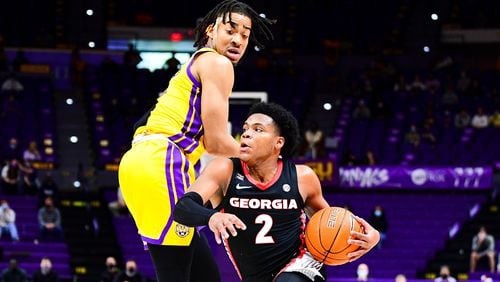 Georgia basketball player Sahvir Wheeler (2) drives past an LSU defender in a game at Pete Maravich Assembly center earlier this season. The Bulldogs' point guard leads the SEC and is fourth nationally in assists at 7.6 per game. (Beau Brune/LSU Athletics)