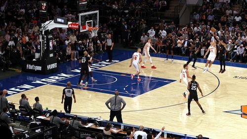 New York Knicks' Derrick Rose (4) makes a 3-point shot as Atlanta Hawks' Bogdan Bogdanovic (13) defends during the fourth quarter of Game 2 in an NBA basketball first-round playoff series Wednesday, May 26, 2021, in New York. (Elsa/Pool Photo via AP)