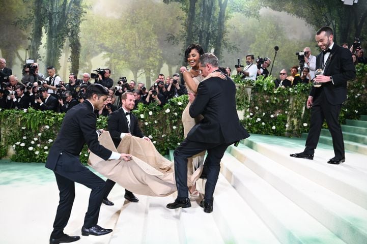 Tyla is helped up the stairs at the Metropolitan Museum of Art's Costume Institute benefit gala in New York, May 6, 2024. (Nina Westervelt/The New York Times)