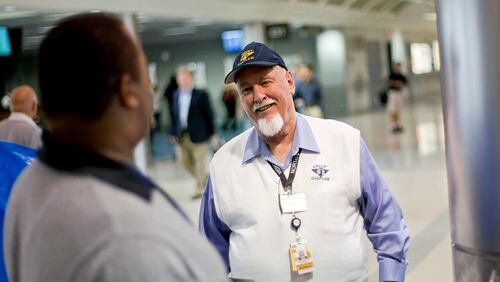 Airport chaplain Rev. Frank Colladay Jr., right, talks with airport worker Lance Norris as he makes his rounds through a concourse at Hartsfield-Jackson International Airport.