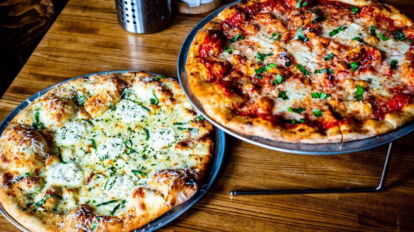 Two pizzas that show off the excellent ratio of sauce to toppings to crust at MTH Pizza are Bianca #5 (left) and the Margherita. CONTRIBUTED BY HENRI HOLLIS