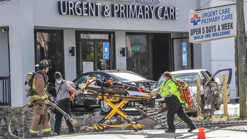 The crash temporarily shut down Howell Mill Road and led to the evacuation of some buildings. A crash victim was taken to the hospital from the scene. (John Spink / John.Spink@ajc.com)