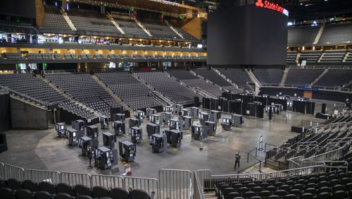 10/7/2020 - Atlanta, Georgia - Fulton County department of registration and elections employees work on securing each voting machine at State Farm Arena in Atlanta, Wednesday, October 7, 2020. (Alyssa Pointer / Alyssa.Pointer@ajc.com)
