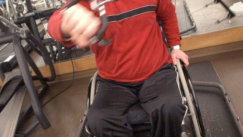 Terry Kirby works out at Shepherd Spinal Center in 2004. He was paralyzed when he was shot during a robbery at Sidelines Sports Grille about two years earlier. (SUNNY SUNG/AJC staff)