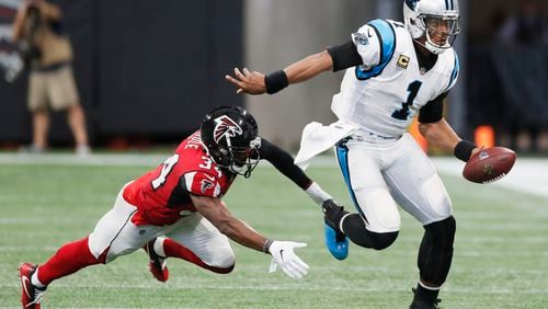 Carolina Panthers quarterback Cam Newton (1) evades Atlanta Falcons cornerback Brian Poole (34) on a keeper in the second half.