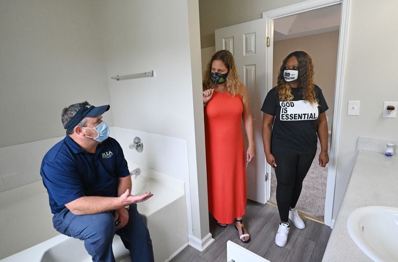 August 21, 2020 Lithonia - Jerry Prato (left), home inspector, talks with home buyer Monica Nash (right) and her agent Jacki Gould as they walk through the house, which there were a multiple offers and it is now under contract to Nash, in Lithonia on Friday, August 21, 2020. Story is about the enthusiastic homebuyers, despite the pandemic. (Hyosub Shin / Hyosub.Shin@ajc.com)