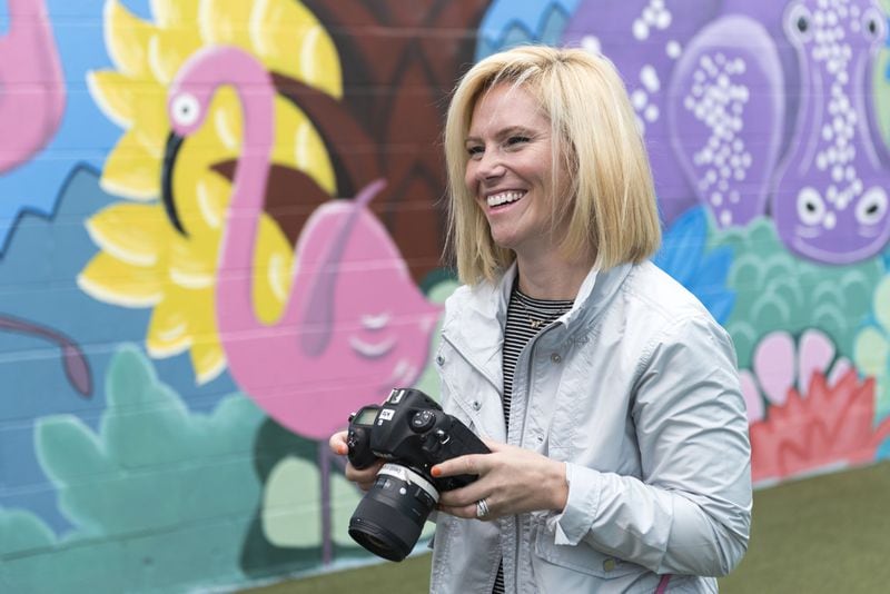 Kate T. Parker photographs girls who are featured in her new photo book, “Strong Is the New Pretty,” at Atlanta Academy. Parker, who lives in Roswell, is a former collegiate soccer player, former CNN video producer and professional photographer. DAVID BARNES / SPECIAL