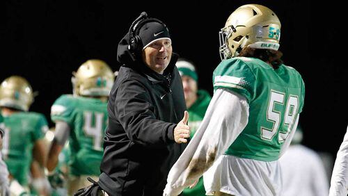 Buford head coach Jess Simpson (left) congratulates offensive lineman Connor Mills after a TD in last week's game.