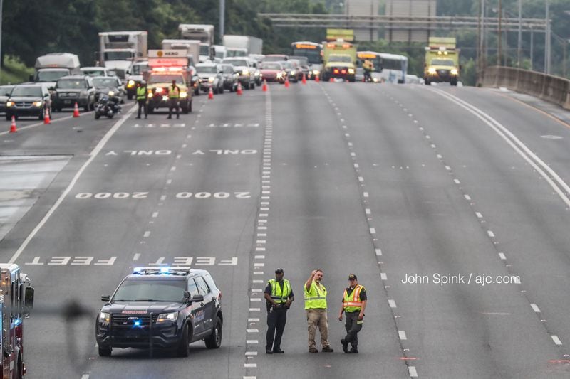 Police, who have been on the scene since 5 a.m., do not know when I-75 North at Cleveland Avenue will reopen. JOHN SPINK / JSPINK@AJC.COM