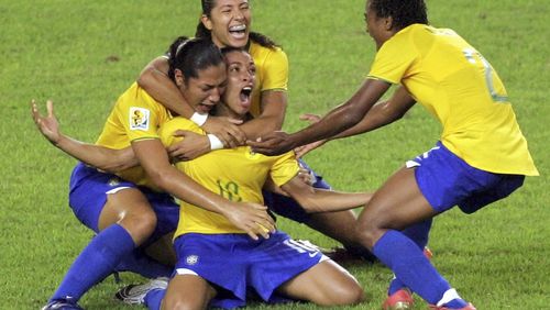 FILE - Brazil's Marta, center, celebrates her goal against the United States during a FIFA Women's World Cup semifinal soccer match in Hangzhou, China, Sept. 27, 2007. The six-time women's world player of the year plans to retire from the national team after 2024. (AP Photo/Greg Baker, File)