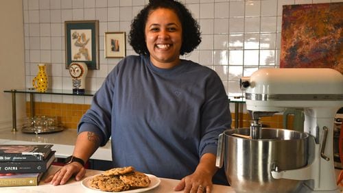 Tiny Lou's executive pastry chef Charmain Ware-Jason poses with her inspirational cookbooks, trusted KitchenAid mixer and a plate of her chocolate chip cookies. (CHRIS HUNT FOR THE ATLANTA JOURNAL-CONSTITUTION)