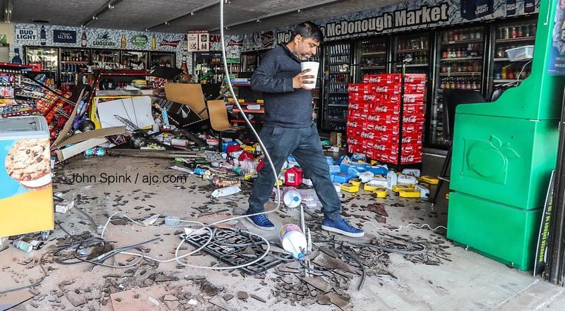 Store manager Tony Patel surveys the damage at McDonough Market on Macon Street after a car plowed through the store. “I feel lucky no one was hurt,” he said.