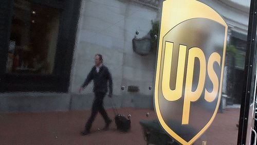 SAN FRANCISCO - FEBRUARY 02:  A pedestrian is reflected in the side of a United Parcel Service (UPS) truck  February 2, 2010 in San Francisco, California. UPS reported a surge in fourth-quarter earnings with a profit of $757 million, or 75 cents a share, compared to $254 million, or 25 cents a share, one year ago. (Photo by Justin Sullivan/Getty Images)