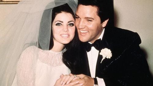 Elvis Presley sits cheek to cheek with his bride, the former Priscilla Ann Beaulieu, following their wedding May 1, 1967.