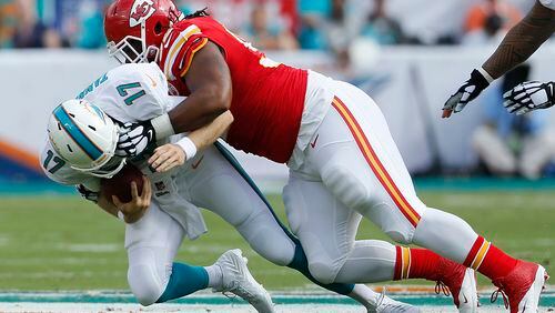 MIAMI GARDENS, FL - SEPTEMBER 21: Quarterback Ryan Tannehill #17 of the Miami Dolphins is brought down by nose tackle Dontari Poe #92 of the Kansas City Chiefs in the first quarter at Sun Life Stadium on September 21, 2014 in Miami Gardens, Florida. (Photo by Joel Auerbach/Getty Images)