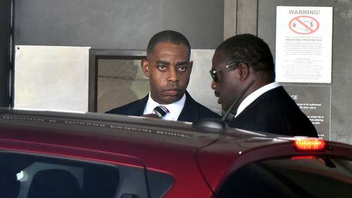 Atlanta’s former chief purchasing officer Adam Smith, left, leaves the federal courthouse in September after pleading guilty to accepting more than $30,000 in bribes from a city vendor. HYOSUB SHIN / HSHIN@AJC.COM