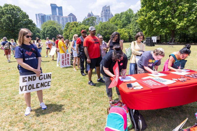 Participants sign in before a rally organized by Georgia Moms Demand Action in Piedmont Park on Saturday, May 13, 2023. The rally was part of a national series of protests the day before Mother’s Day to highlight the mounting toll of gun violence. (Steve Schaefer/steve.schaefer@ajc.com)