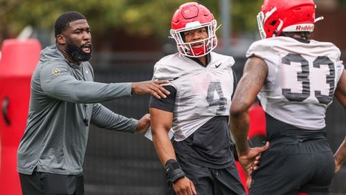 An injured Nolan Smith (4), who is out for the season, has been coaching Robert Beal (33) and UGA's other outside linebackers in practice. (Photo by Mackenzie Miles/UGA Athletics)