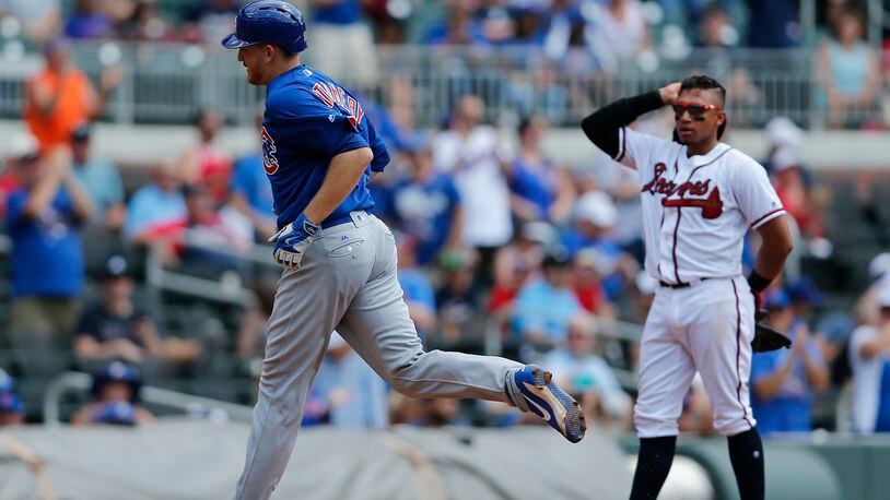 Chicago Cubs pitcher Mike Montgomery (38) runs past Atlanta Braves third baseman Johan Camargo (17) as he rounds the bases after hitting a home run in the fifth inning of a baseball game Wednesday, July 19, 2017, in Atlanta. (AP Photo/John Bazemore)