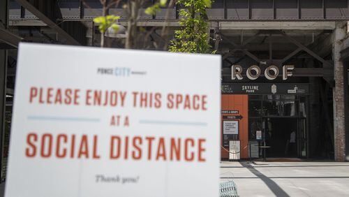 A sign encouraging social distancing is displayed at Ponce City Market in Atlanta’s Old Fourth Ward community May 4, 2020. ALYSSA POINTER / ALYSSA.POINTER@AJC.COM