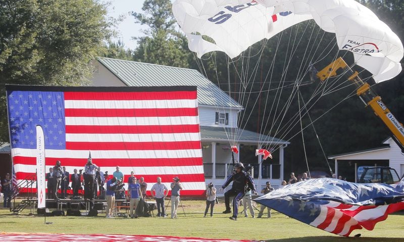 Skydivers parachuted into the yard outside the Barnesville home donated to Gold Star widow Sarah Schaaff by the Tunnel to Towers Foundation. BOB ANDRES /BANDRES@AJC.COM