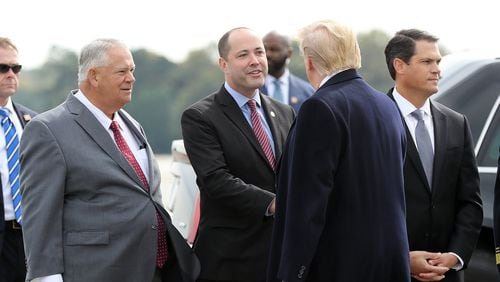 Georgia House Speaker David Ralston (left), Attorney General Chris Carr (center), and Lieutenant Governor Geoff Duncan (right) greet President Donald Trump after he arrived at Dobbins Air Reserve Base on Nov. 8, 2019. Curtis Compton/ccompton@ajc.com