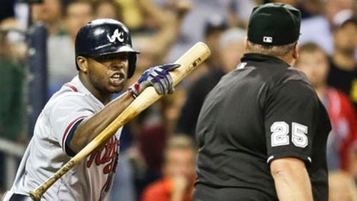 Atlanta Braves' Justin Upton rants against home plate umpire Fieldin Culbreth after being called out on strikes to end the eighth inning against the San Diego Padres in a baseball game in San Diego, Tuesday, June 11, 2013. (AP Photo/Lenny Ignelzi)