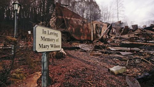 Smoke rises from the remains of the Alamo Steak House Wednesday, Nov. 30, 2016, in Gatlinburg, Tenn., after a wildfire swept through the area Monday. Three more bodies were found in the ruins of wildfires that torched hundreds of homes and businesses in the Great Smoky Mountains area, officials said Wednesday. (AP Photo/Mark Humphrey)