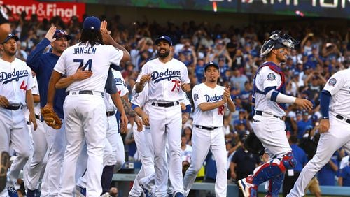 Los Angeles Dodgers players celebrate after securing the National League West division title with Monday's win over Colorado.  (Photo by Jayne Kamin-Oncea/Getty Images)