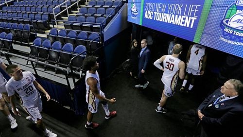 Florida State players leave the court after games at the ACC Tournament in Greensboro, N.C., were canceled Thursday, March 12, 2020, due to the coronavirus. A year after the worldwide coronavirus pandemic stopped all the games in their tracks, the aftershocks are still being felt across every sector.  (Gerry Broome/AP)