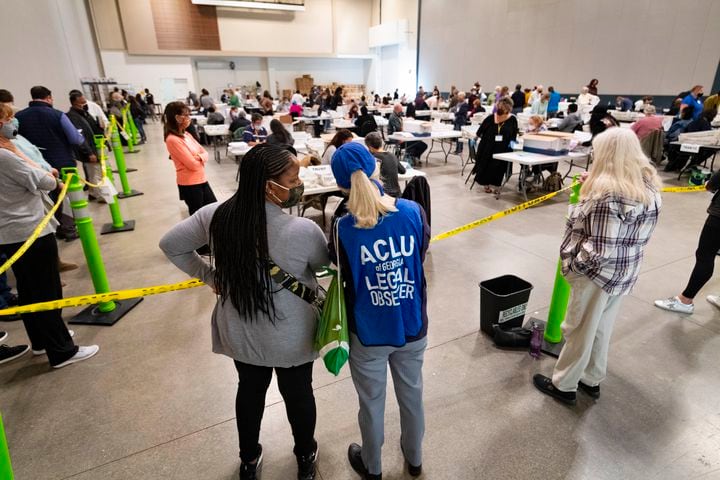 Democrat observers confer as they look on during a Cobb County hand recount of Presidential votes on Sunday, Nov.15, 2020, at the Miller Park Event Center in Marietta. (JOHN AMIS FOR THE ATLANTA JOURNAL-CONSTITUTION)