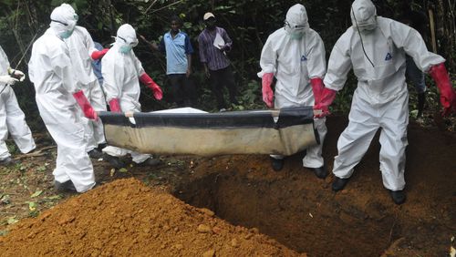 FILE : In this Saturday, Oct. 18, file photo a burial team in protective gear bury the body of a woman suspected to have died from Ebola virus in Monrovia, Liberia. The disease has ravaged a small part of Africa, but the international image of the whole continent is increasingly under siege, reinforcing some old stereotypes. (AP Photo/Abbas Dulleh, File) In this Saturday photo a burial team in protective gear bury the body of a woman suspected to have died from Ebola virus in Monrovia, Liberia. The disease has ravaged a small part of Africa, but the international image of the whole continent is increasingly under siege. AP /Abbas Dulleh