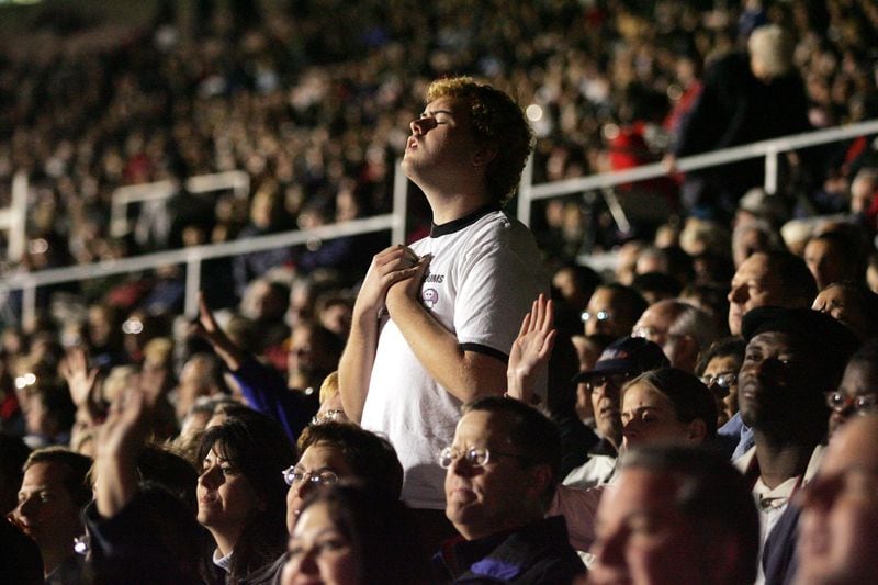 Worshippers listen to the Rev. Billy Graham speak at the Rose Bowl in Pasadena, Calif., on Nov. 18, 2004. Graham, a North Carolina farmer’s son who preached to millions in stadium events he called crusades, becoming a pastor to presidents and the nation’s best-known Christian evangelist for more than 60 years, died on Wednesday, Feb. 21, 2018, at his home in North Carolina. He was 99. MONICA ALMEIDA / THE NEW YORK TIMES