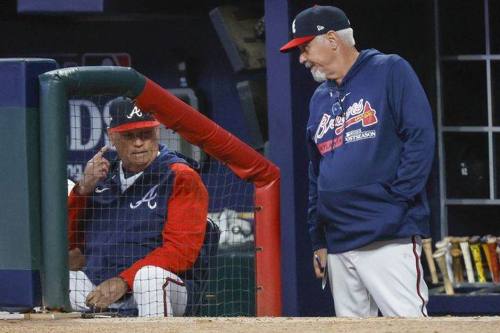 Atlanta Braves manager Brian Snitker (left) and pitching coach Rick Kranitz confer during the fourth inning of NLDS Game 2 against the Philadelphia Phillies in Atlanta on Monday, Oct. 9, 2023.   (Miguel Martinez / Miguel.Martinezjimenez@ajc.com)