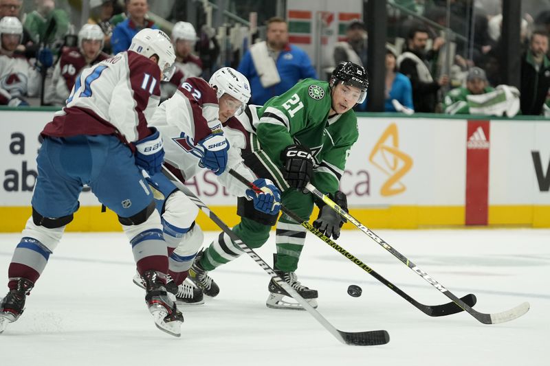 Colorado Avalanche's Andrew Cogliano (11), Artturi Lehkonen (62) and Dallas Stars' Jason Robertson, right, compete for control of the puck in the first period in Game 2 of an NHL hockey Stanley Cup second-round playoff series in Dallas, Tuesday, May 7, 2024. (AP Photo/LM Otero)