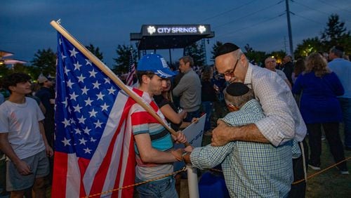 Thousands of Israel supporters, including Yosef Fried, from left, Yosef Ovadia and Yisrael  Herscovici of Beth Jacob gather inside and outside of City Springs in Sandy Spring on Tuesday, Oct 10, 2023 for a rally for Israel. (Jenni Girtman for The Atlanta Journal-Constitution)