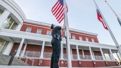 Flags were at half staff Monday morning at Clayton County police headquarters. JOHN SPINK / JSPINK@AJC.COM