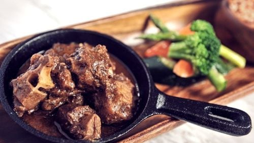 This oxtail stew is served in a personal-size skillet. Contributed by Negril Village Atlanta.